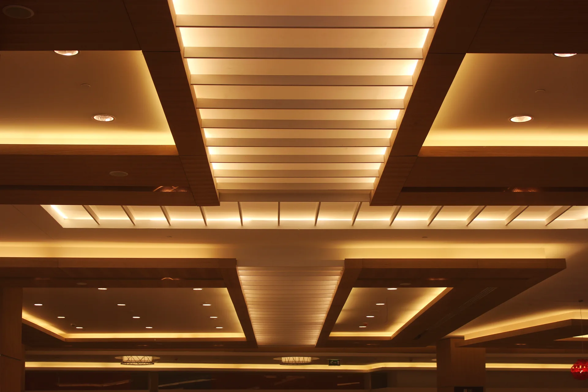Layered coffered ceiling with concealed lighting over the retail floor