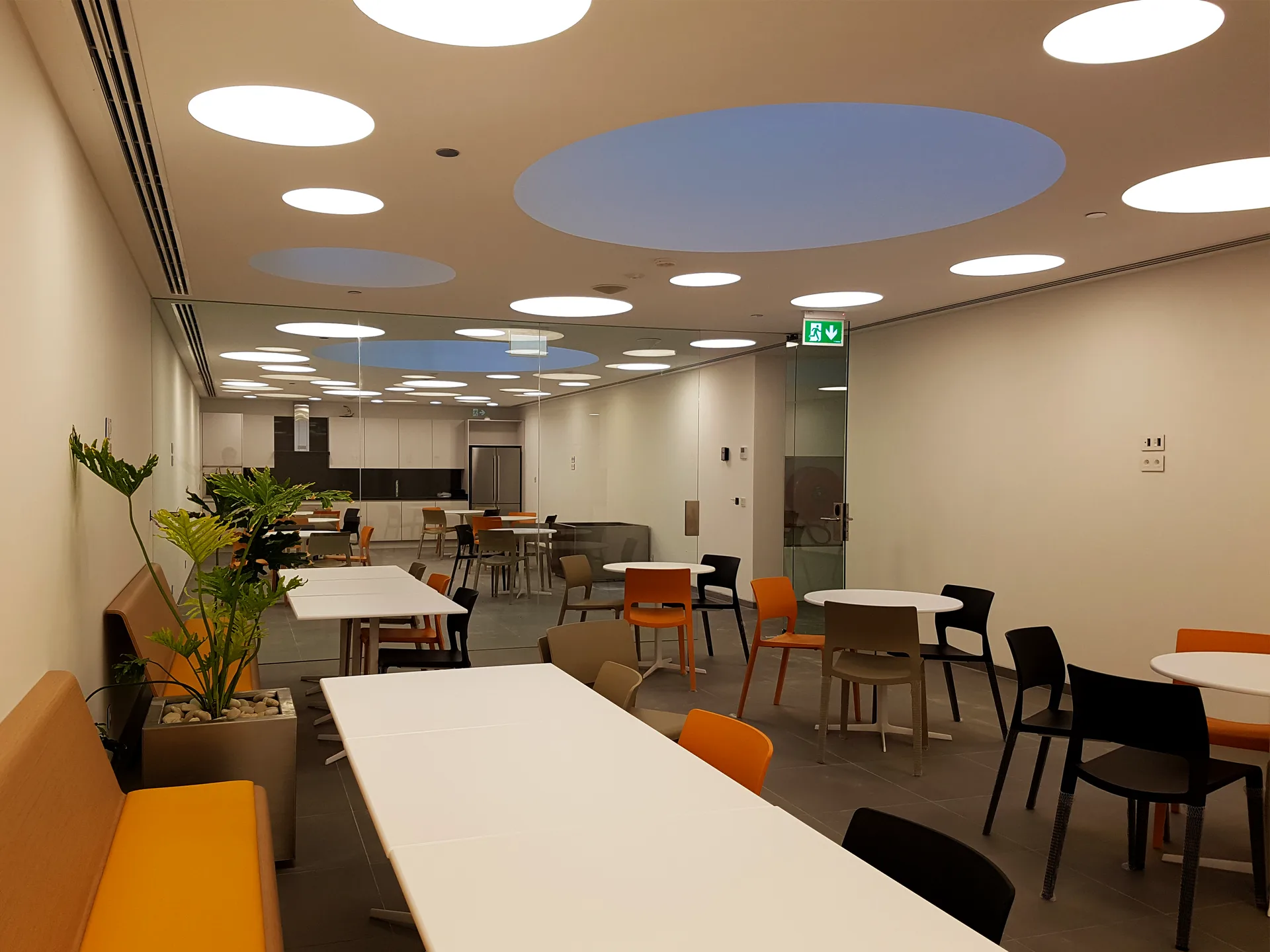 Staff dining area under a sky-panel ceiling with circular light coffers