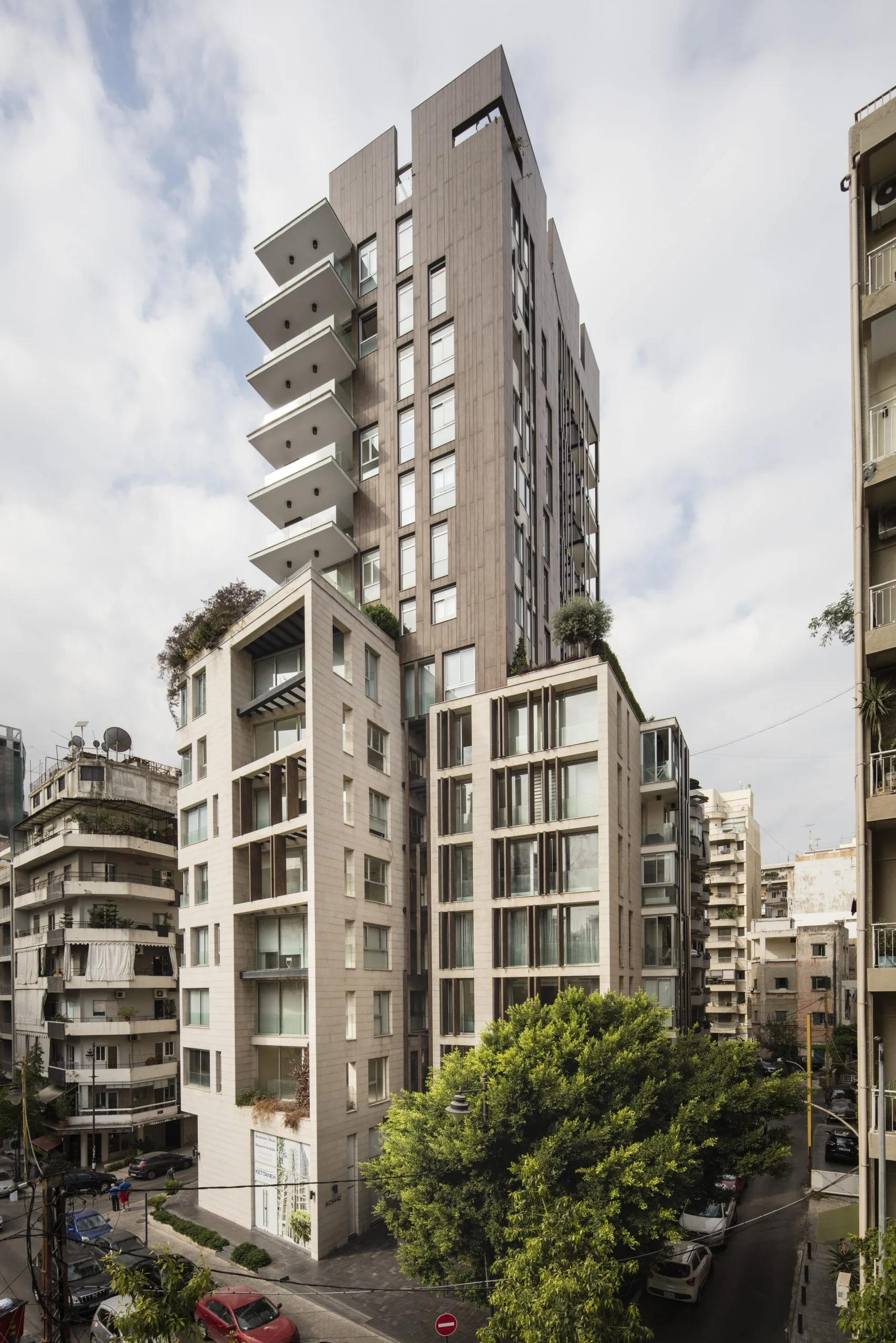 Sursock Yards — stone-clad residential tower with cantilevered balconies over Achrafieh