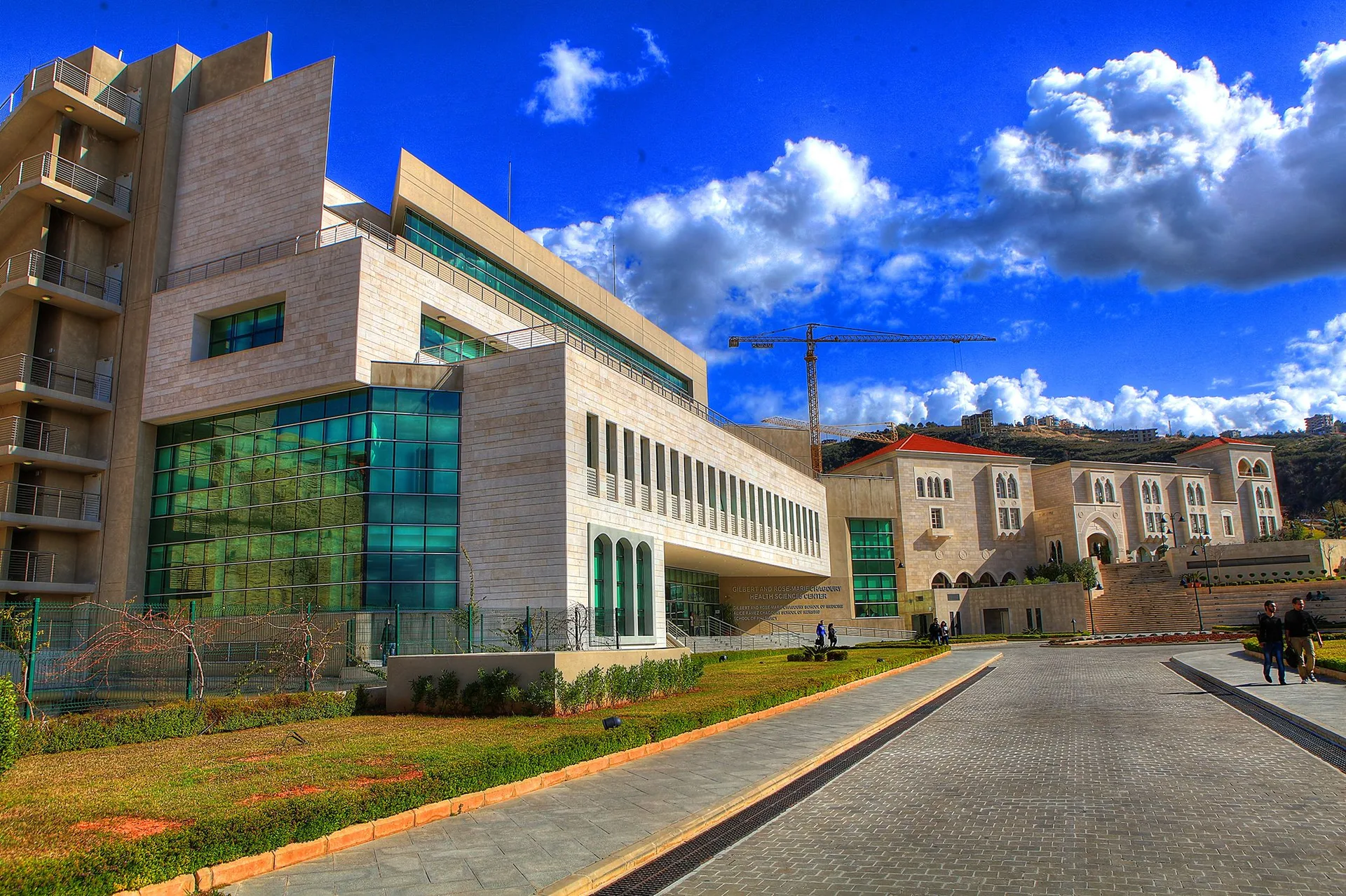 LAU Byblos dormitories — stone and glazed blocks on the hillside campus