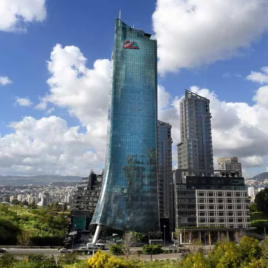 Credit Libanais headquarters — the curved green-glass tower above the coastal highway