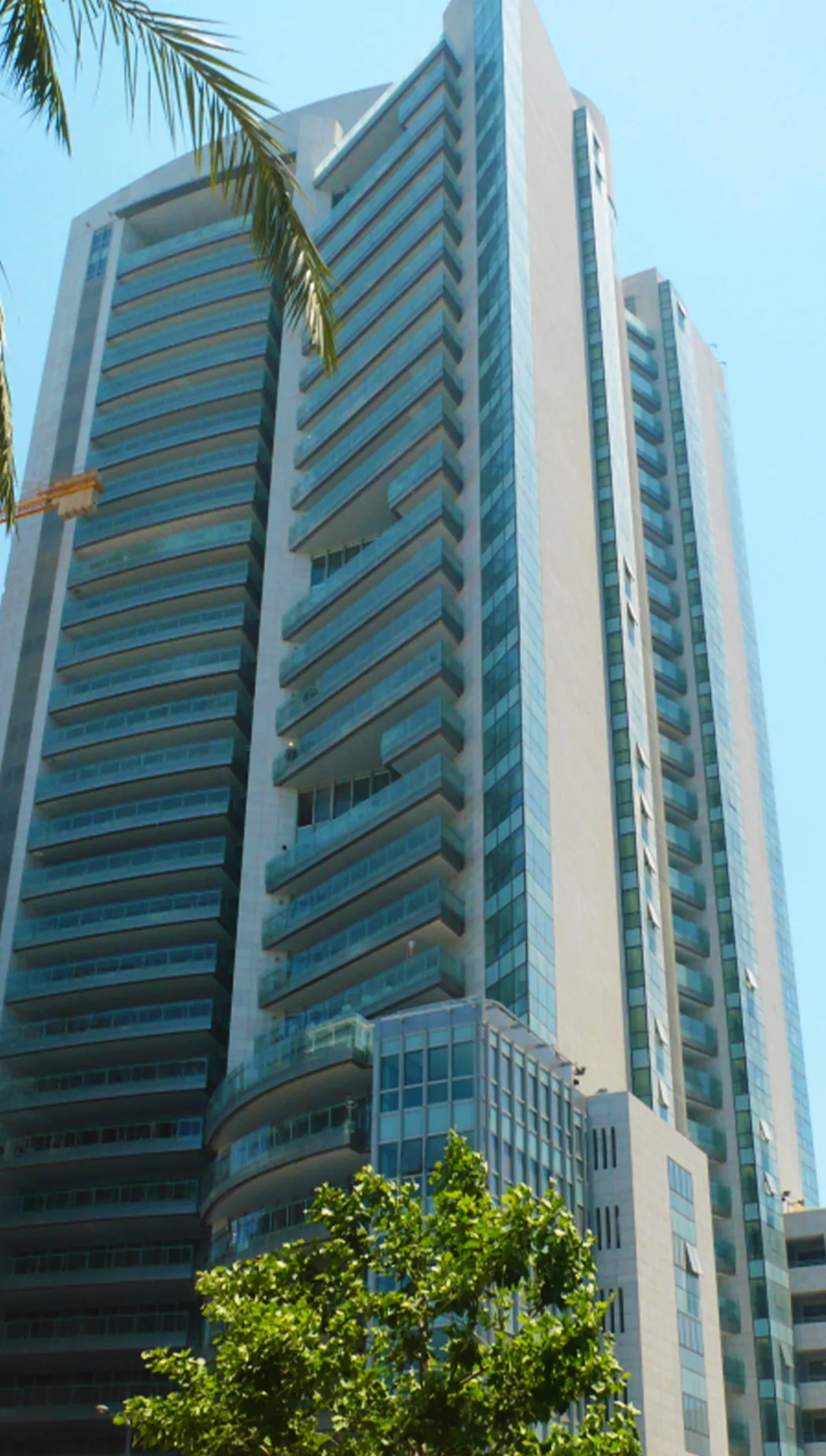 Beirut Tower — banded glass and balcony residential high-rise seen from street level