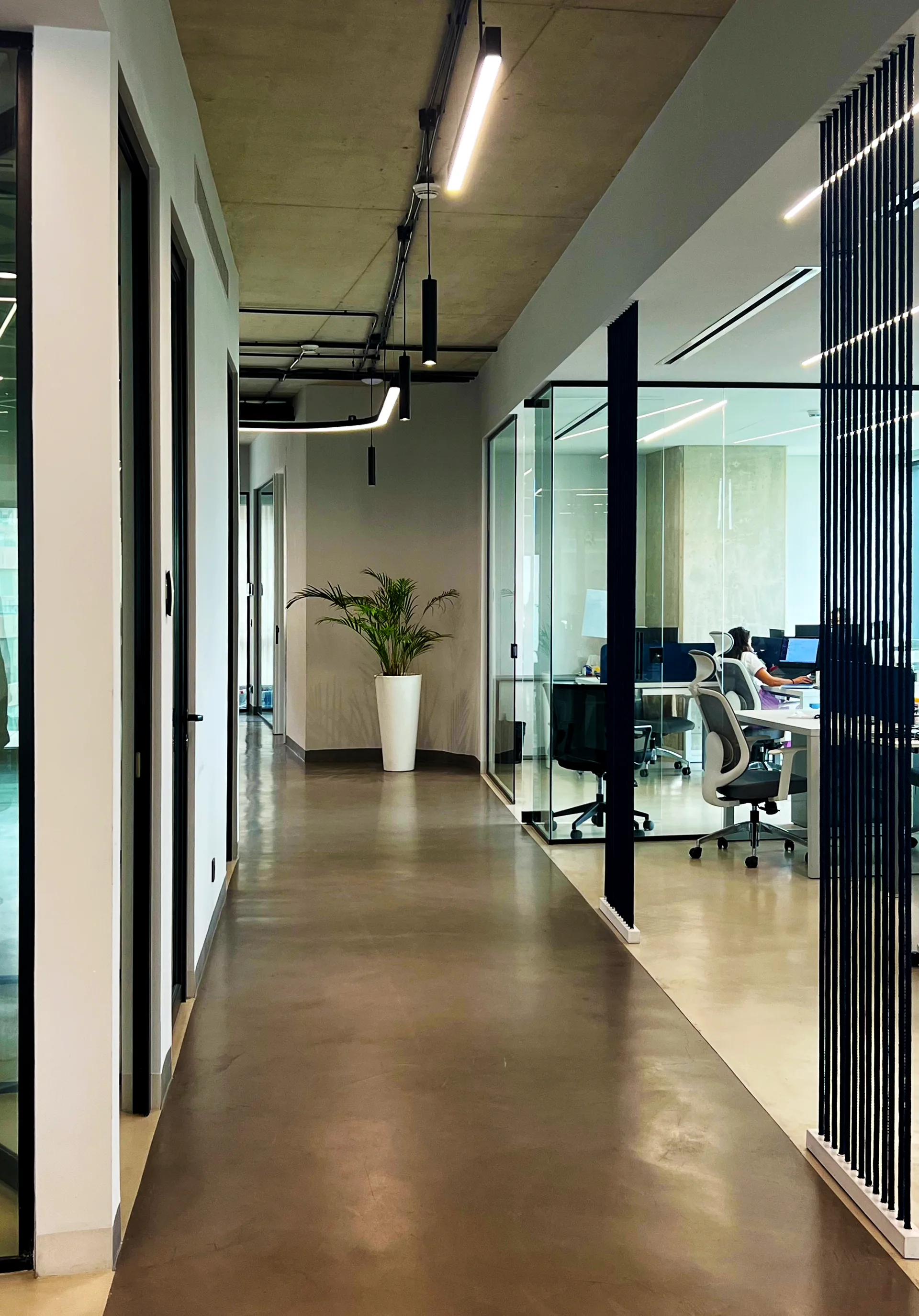 Office corridor with glazed partitions, timber screening and exposed services