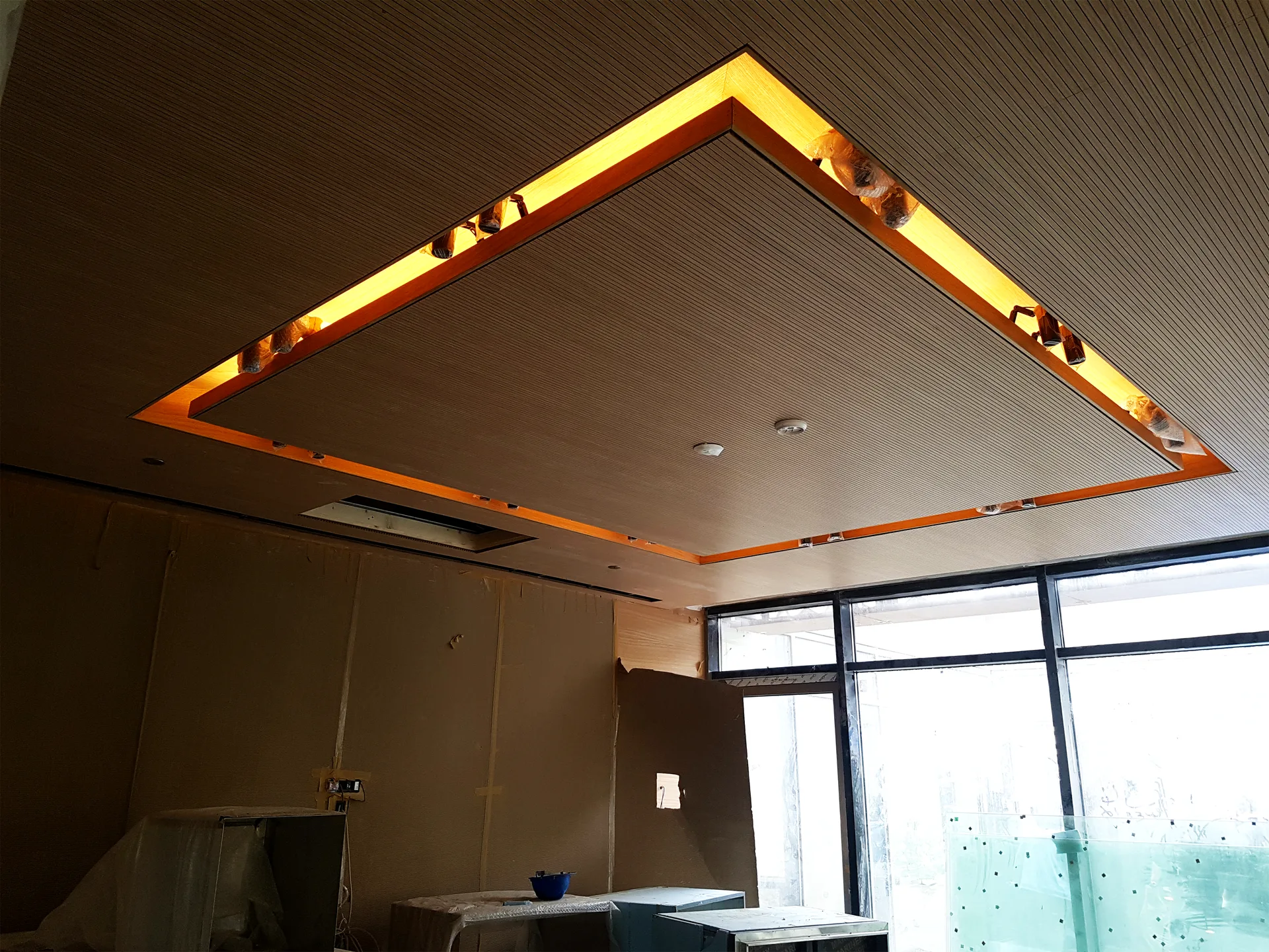Ribbed timber ceiling raft with an illuminated onyx perimeter detail