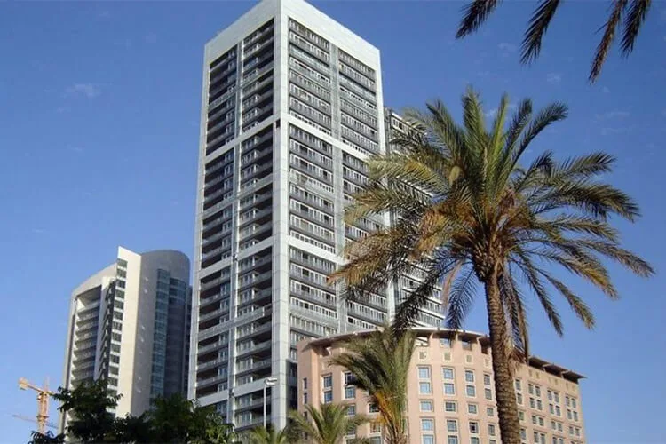 Platinum Tower, Beirut — residential high-rise seen through palms