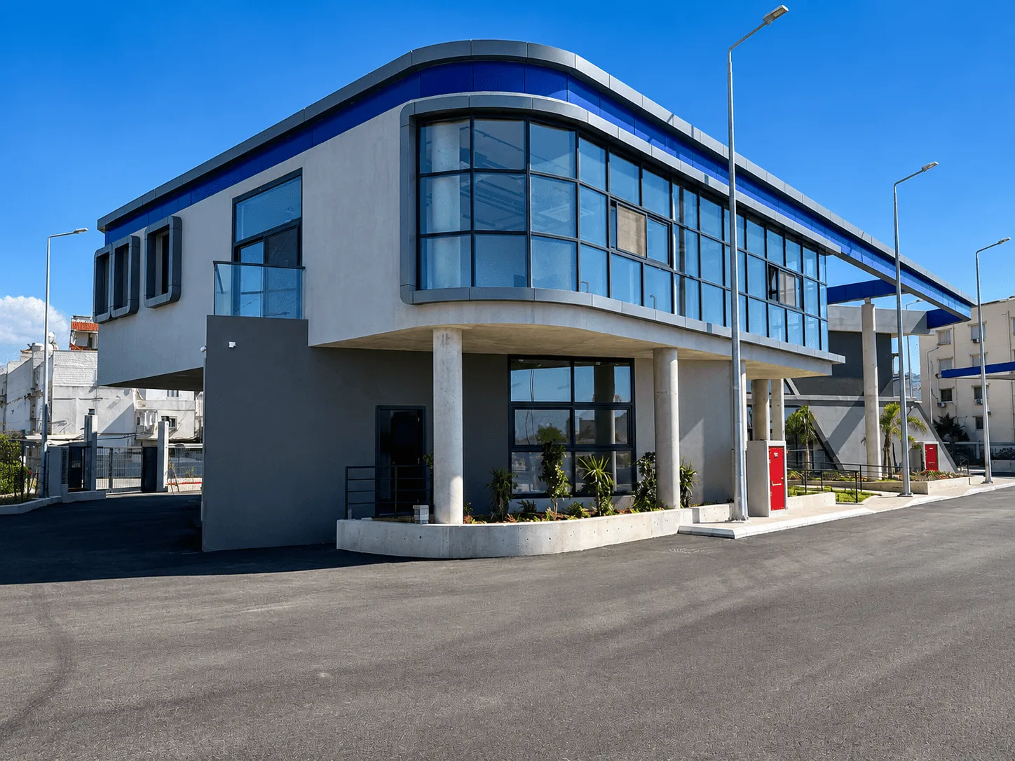 Administration building — curved curtain-wall corner and entrance canopy